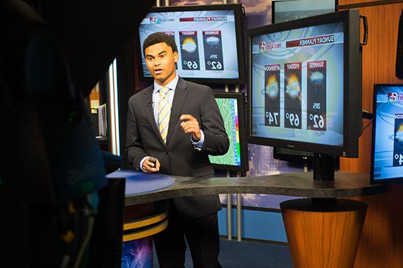 Student doing weather at KOMU TV station